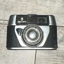 Regulette Coloris Conar 12.845 appareil photo argentique compact argent noir